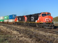 CN 2271 leads an eastbound IM down the south track at Clover Bar as it prepares to meet CN 2874 leading a westbound IM. There is a 20 year difference in age between these DC units with the 2271 being purchased just 12 years ago in 2007. It will be another 6 years from 2007 before CN takes a turn at buying AC power. This will lead to buying the new A1A trucked GE's with the load sensitive idler. I did not expect to see the return of the A1A, thinking the GMD-1 would be the last.