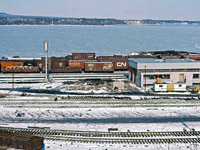The new CN diesel shop in Hamilton nears completion in February 1964. As interesting is the mix of rolling stock in the North Yard, including many "fallen flags". Also note the number of tracks north of the main lines...in the 1960s, Hamilton Yard had tracks both on both sides of the Oakville sub mainline.
