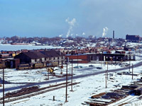 In the year 1964, CN's facilities in Hamilton received a major modernization, with the construction of a new Diesel shop and Express building/Carload Centre. In this view from early 1964, we see the Great Western era steam facilities which were demolished later that spring; beyond the roundhouse you can see the old Yardmaster's tower. Visible in the photo are two MLW S4 locomotives (8163 and an unidentified unit), two SW1200RS units (1316 and another unit), and RS18 3677.