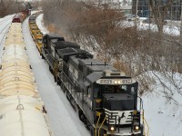 A transfer for the Port of Montreal with empty well cars heads east through Montreal West with a pair of now retired NS standard cab GE's (NS 8821 & NS 8698). At left is CN X309. NS 8821 was rebuilt into NS 4063, which was wrecked and scrapped in 2018. 