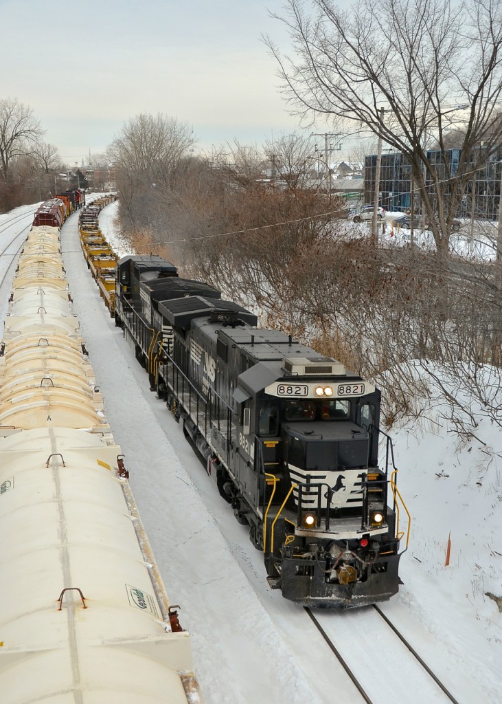A transfer for the Port of Montreal with empty well cars heads east through Montreal West with a pair of now retired NS standard cab GE's (NS 8821 & NS 8698). At left is CN X309. NS 8821 was rebuilt into NS 4063, which was wrecked and scrapped in 2018.