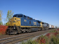 With only 54 cars in tow, CN 327 heads west on the north track as it approaches Caron at MP 19.7 of CN's Kingston Sub. Power is CSXT 9051 & CSXT 9027, both Dash8-44CW's. This CSX-only model is a Dash8-40CW externally, but a Dash9 internally. Built with 4400 horsepower, they have since been derated to 4000 horsepower and CSX now classifies them as CW40-9's.