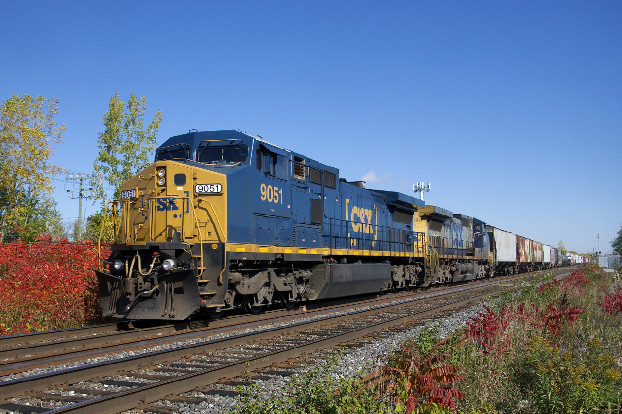 With only 54 cars in tow, CN 327 heads west on the north track as it approaches Caron at MP 19.7 of CN's Kingston Sub. Power is CSXT 9051 & CSXT 9027, both Dash8-44CW's. This CSX-only model is a Dash8-40CW externally, but a Dash9 internally. Built with 4400 horsepower, they have since been derated to 4000 horsepower and CSX now classifies them as CW40-9's.