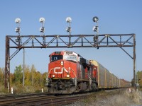 CN 271 with 112 autoracks passes underneath a classic signal gantry near MP 28 of CN's Kingston Sub with CN 2255 & CN 2137 for power.