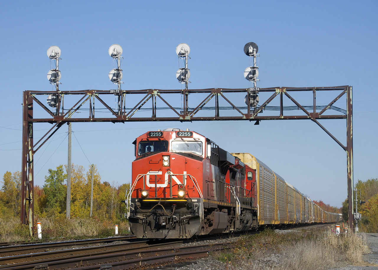 CN 271 with 112 autoracks passes underneath a classic signal gantry near MP 28 of CN's Kingston Sub with CN 2255 & CN 2137 for power.