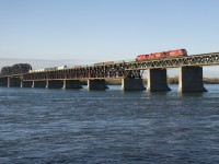 CP 253 is crossing over the St. Lawrence River on a sunny fall morning. Leading is nearly brand new rebuild CP 8069, with CP 8151 & CP 2252 trailing. CP 2252 is going to the St-Luc shops for servicing after use on D&H local CP D11 during the week.
