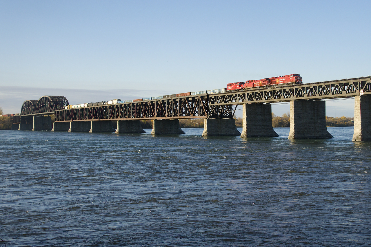 CP 253 is crossing over the St. Lawrence River on a sunny fall morning. Leading is nearly brand new rebuild CP 8069, with CP 8151 & CP 2252 trailing. CP 2252 is going to the St-Luc shops for servicing after use on D&H local CP D11 during the week.