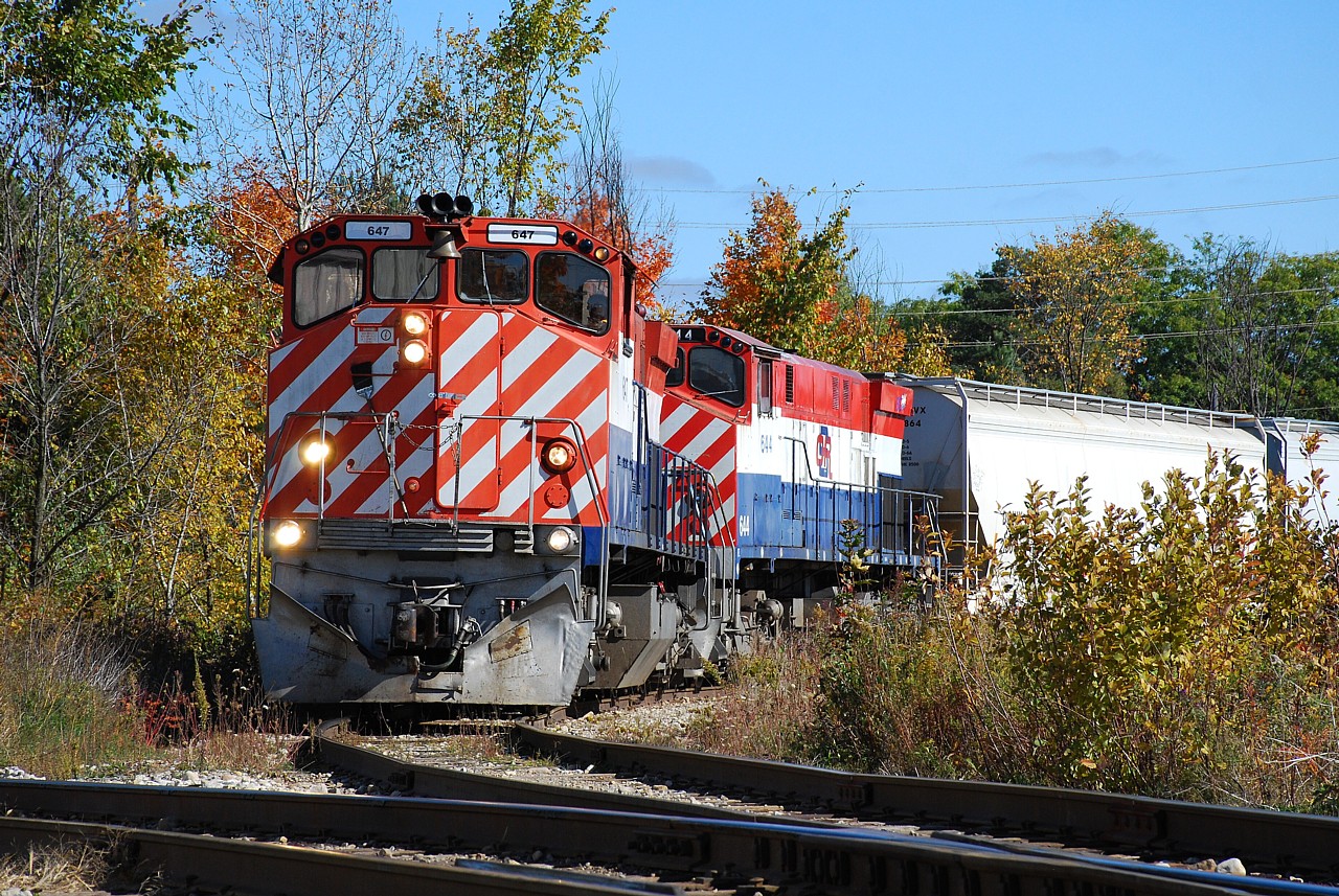 OSR M-420(W)s 647 and 644 back off the north industrial spur with four hoppers.  Their next task was to switch the south industrial spur, however CN 540 was on it.  What to do?  Walk to Tim Horton's of course.  I find Guelph horribly frustrating to navigate and lucked out with this shot.  I had abandoned my OSR chase to go search for CN 540... finding CN 542 instead.  After photographing 542 at Guelph Jct. I then found 540 on the Fergus Spur.  Not finding anywhere to photograph 540 I gave up, got twisted around in the industrial area and found OSR again.  You can plan all you want but sometimes the subjects you just happen upon end up being the best photos of the day.  It was today!
