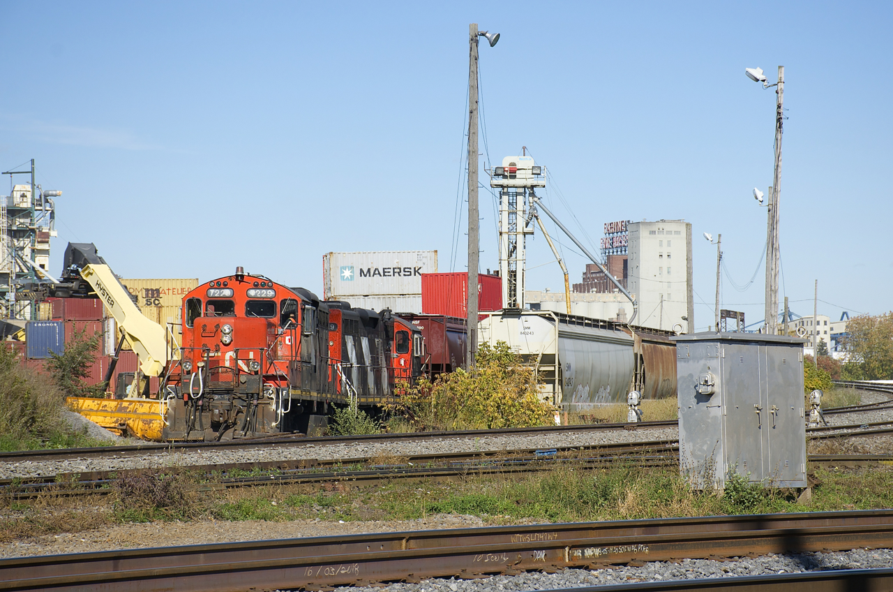 CN 7229 & CN 4129 are about to leave Ray-Mont Logistics after dropping of three loaded grain cars. This client is located adjacent to CN's Montreal Sub and Pointe St-Charles Yard and grain is transloaded here for further shipment.