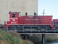 DLCX 1202 is the latest plant switcher at the P&H elevator in Moose Jaw.  Adorned in the colours of the NCAA Nebraska Cornhuskers, this unit looks quite out of place in the middle of "Rider Nation".  