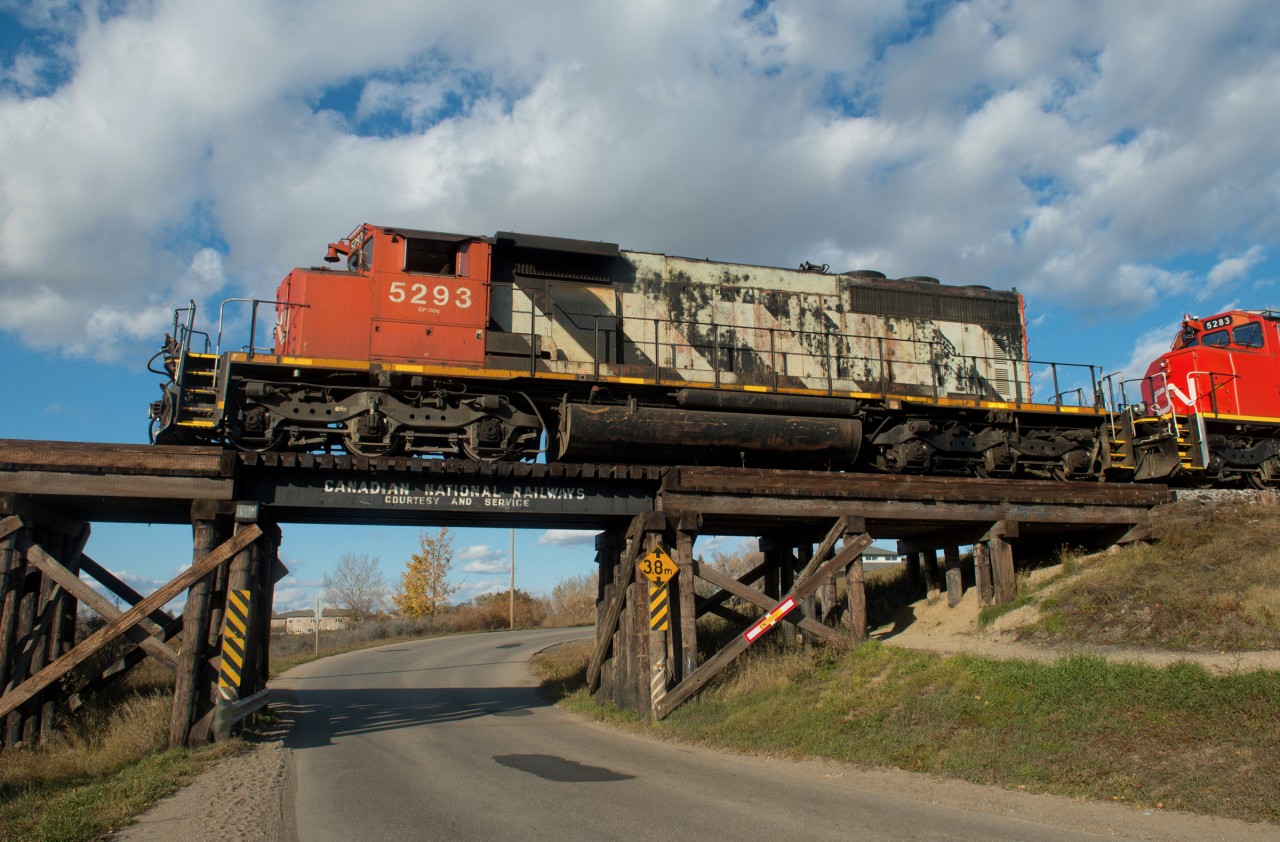 CN 5293 is seen leading a set of light power on the Central Butte Sub through the north end of Moose Jaw Saskatchewan. There are no less than three bridges in town with similar paint jobs.