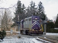 GEXR GP38 3843 runs solo long-hood forward, seen crossing Aberdeen Street heading towards Paisley Street on the Guelph North Spur during March 2002. 3843 originally operated for the L&N, Seaboard and CSX before being sold to the North Carolina and Virginia Railroad (NCVA), where it acquired its purple and silver paint scheme. The colours earned it the nickname of "Barney", but the unit left the GEXR when it was sent to the New England Central in 2006.