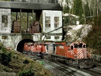 A westbound exits Connaught tunnel at the summit of Rogers Pass. Today this line only sees eastbounds with westbounds using the 1986 constructed Mount MacDonald line