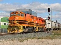 Goderich-Exeter Railway (GEXR) train 516 with GEXR GP40-2L(W) 3030 and QGRY GP38-2 2008 have just reversed off the Huron Park Spur in Kitchener and are viewed throttling-up westward for Stratford at Kitchener West.  