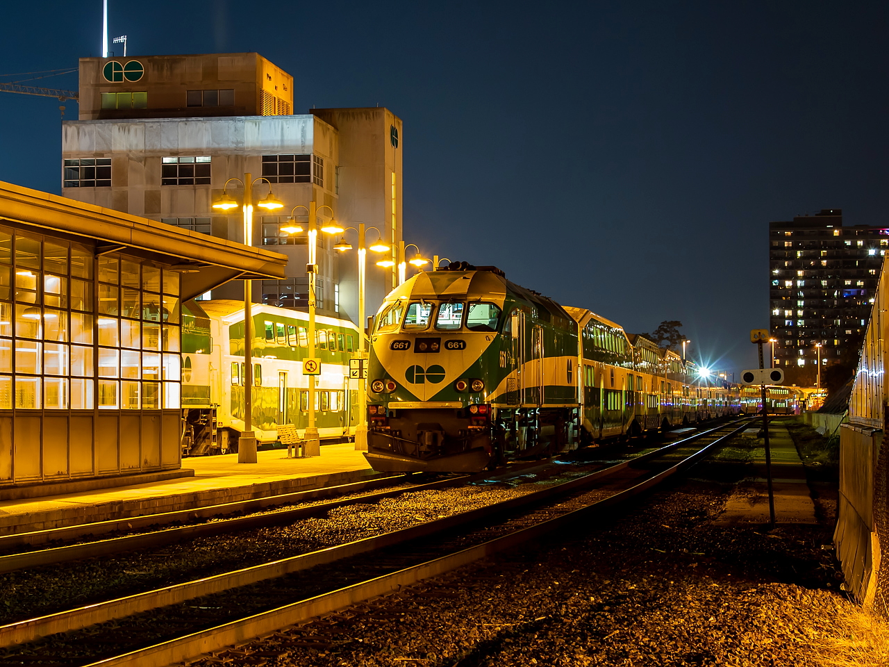 I was out for a walk on this nice, crisp Fall night and was heading home when I passed by the GO station and saw what I thought was a pretty photogenic scene even if it was just an MP40 providing the subject. I don't live all that far from the GO Station so I went home and got my camera and returned to do some nights shots. This area is fenced off so I didn't even bother to bring my tripod as I didn't think it would be of much use given the fence, and instead used the chain link fence itself to stabilize the camera. While I was shooting, someone showed up and fired 661 up, which is why the cab is lit up in this shot.