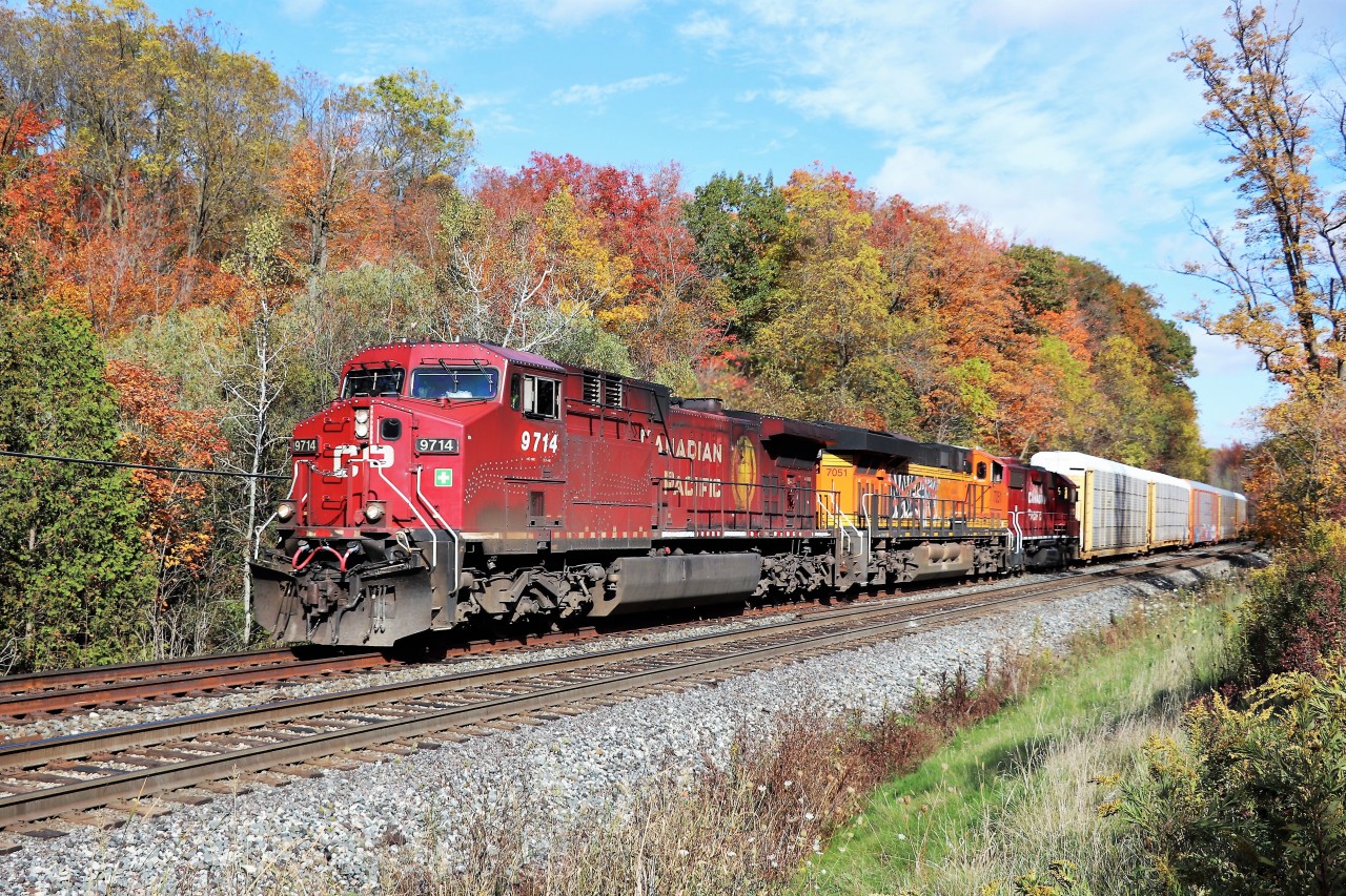 With the CP Holiday train schedule getting released for this year, a former Holiday Train leader from the past made an appearance today. Having made its last run on the 'Christmas Train' in 2007, CP 9714 with a Graffiti ridden BNSF 7051 and CP 3113 rumble up the North track approaching Guelph Line on their way for work at Guelph Junction. The fall colours and bright sunny day and the fact that this is on the North track made for perfect conditions.