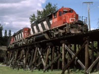 A pair of SD38-2's cross Kalamalka Road on Vernon's south side adjacent to Kalamalka Lake beach with a turn to Lumby