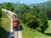 Kids heading down the hill toward fishing wait as a pair of GEXR geeps give 'er with all their might to climb the 2.8 percent grade up the hill to the Goderich station from the Compass Minerals salt mine (far background). With 14 loads on the drawbar, it was a bit of a struggle, but no match for this 5000 horsepower pair which sounded amazing climbing the hill. Not many GP40's left on G&W around here and I'm surprised this one has survived as long as it has, most have been traded in. Compare to <a href=http://www.railpictures.ca/?attachment_id=28848 target=_blank> Arnold's shot from a bit down the hill</a> which is now overgrown,  at least you can still get the CP Goderich sub in the photo from the HWY 21 overpass. No place to park though, beware.