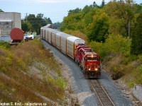 Only the Engineer's side Class light functions, and it's turned on. CP T72 is about to duck under Highway 24 in Galt destination Wolverton with the elusive SOO 4410 in the lead. This unit came from St. Paul and is one of a very small handful still active in SOO paint, which can be counted on a single hand. This thing didn't lead all that often... and since it's still in the area (Toronto at last check) it may lead something again in the area. Cross fingers.<br><br>In background is Babcock and Wilcox (BWXT) which rosters 2 switchers of their own. Both CN and CP service this facility, this is the end of the CN Fergus spur at top of that hill - CPR Waterloo sub adjacent.