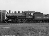 Roberval & Saguenay 2-6-0 #14 (a 2-6-0 "Mogul" Built for the R&S by MLW in 1926, later sold to the Alma & Jonquieres in 1941) is pictured by the railway's roundhouse in Arvida QC, circa 1940.
<br><br>
Bill Thomson collection photo (photographer unknown).
