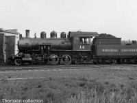 Roberval & Saguenay 2-6-0 #14 (a 2-6-0 "Mogul" Built for the R&S by MLW in 1926, later sold to the Alma & Jonquieres in 1941) is pictured by the railway's roundhouse in Arvida QC, circa 1940.
<br><br>
Bill Thomson collection photo (photographer unknown).