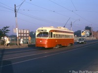 TTC PCC 4390 (an A6-class car built new for the TTC by CC&F in 1948) operates on the Dundas route, stopped at the corner of Dundas Street West and Sterling Road to let off some morning passengers heading to work, before continuing east bound for <a href=http://www.railpictures.ca/?attachment_id=30851><b>City Hall Loop</b></a> downtown. The sun angle and workers lunch bags and boxes suggest this is a weekday morning shot, most probably heading to some of the numerous local businesses and industries in the area to start another workday (this slide was dated for June 10th, which in 1973 fell on a Sunday, so the exact date is suspect).<br><br>A pair of overpasses along this section of Dundas St. W. carry vehicular traffic over rail lines in the area, including the one pictured that spans the CN & CP lines running between "The Junction" (West Toronto) and downtown Toronto. Visible in the background is the building for Wellinger & Dunn Limited off Sorauren Avenue ("Winn Well Sporting Goods" - hockey gear, baseball gear, leather boxing gloves, etc. Today the building has since been converted into condos) and a billboard advertising Doctor Fowler's Extract of Wild Strawberry ("To Relieve Diarrhea Fast"!).<br><br><i>William F. Herrmann photo, Dan Dell'Unto collection slide.</i>