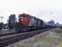 Westbound CN freight train at Pointe-Claire QC, powered by GMDD SD40 CN 5060 and EMD GP9 C&O 6247. <br>
From the crewman's posture, the train is either moving slowly or halted - the bird is much faster.<br><br>
CN and CP main lines run parallel in the western part of Montreal Island, CP tracks can be seen on the north side.<br>
Location mapped is approximate.
