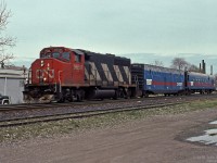 CN 9658, a GMDD GP40-2W built in 1976, leads a CN Engineering TEST train through Hamilton. First car is CN 15007.<br><br>
Slide mount indicated Gage Avenue Hamilton as location. Current views near that crossing do not show the same landmarks, things change. 