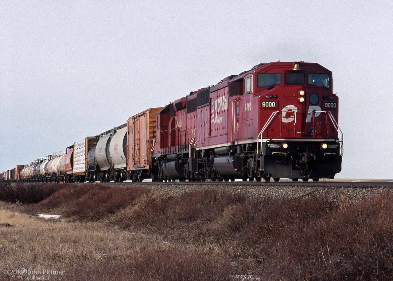 GMDD SD40-2F CP 9000, repainted in the CP Rail System dual flags colour scheme, pulls mixed freight with the assistance of an SD40-2 with all cab windows painted red, restricting it to trailing use and not for occupancy - B-unit status.
Irvine is a small community along the Trans Canada Highway about 22 rail miles east of CP Medicine Hat.