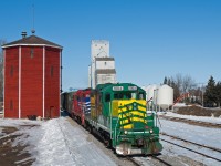 Carlton Trail Railway makes its way south through Hague SK on the line between Prince Albert and Saskatoon. While the brilliant CN water tower can still be seen today, the same unfortunately can not be said about the grain elevator in the background. 
