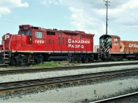 GP9 mother SW8 slug daughter set idling on the east end of the shop tracks.