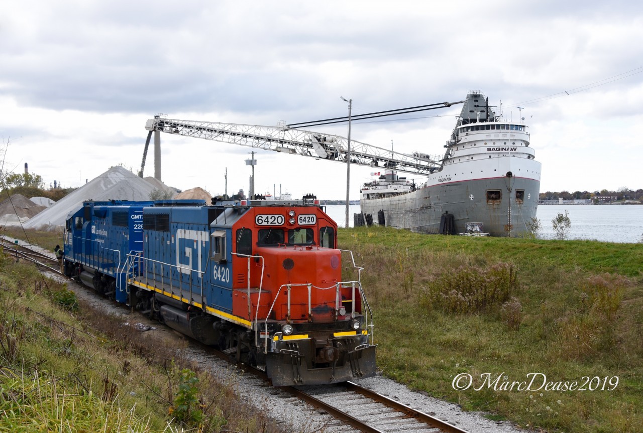 Sarnia may not be the best place for rail photography but it's Number ONE for Great Lakes Freighters in my opinion. Here GTW 6420 and GMTX 2255 return light power after dropping about a dozen cars at the elevator and pass the 1953 built classic Saginaw offloading stone at the Sarnia City Dock.