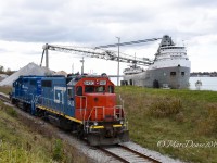 Sarnia may not be the best place for rail photography but it's Number ONE for Great Lakes Freighters in my opinion. Here GTW 6420 and GMTX 2255 return light power after dropping about a dozen cars at the elevator and pass the 1953 built classic Saginaw offloading stone at the Sarnia City Dock.