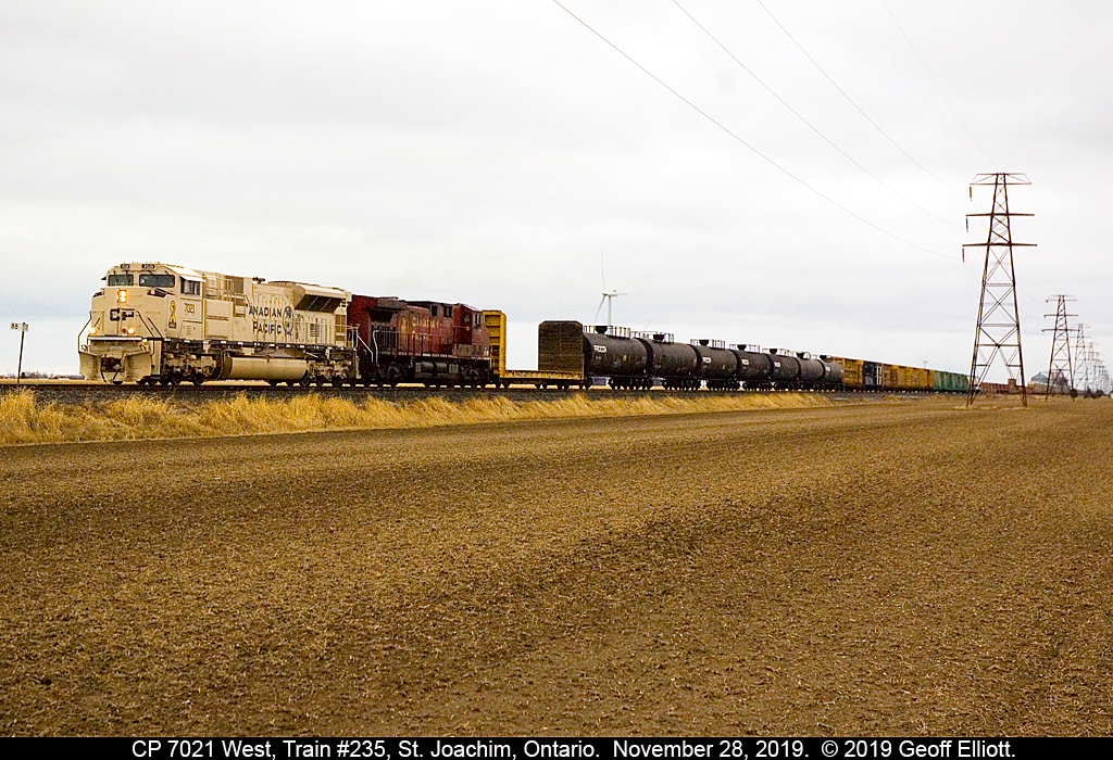Canadian Pacific SD70ACU #7021, in it's "Support Our Troops, Army Arid Regions" scheme leads Detroit bound train #235 through the flatlands of Essex County on November 28th just east of St. Joachim, Ontario. These 5 units are a fitting tribute by Canadian Pacific to those that preserve our freedom.
