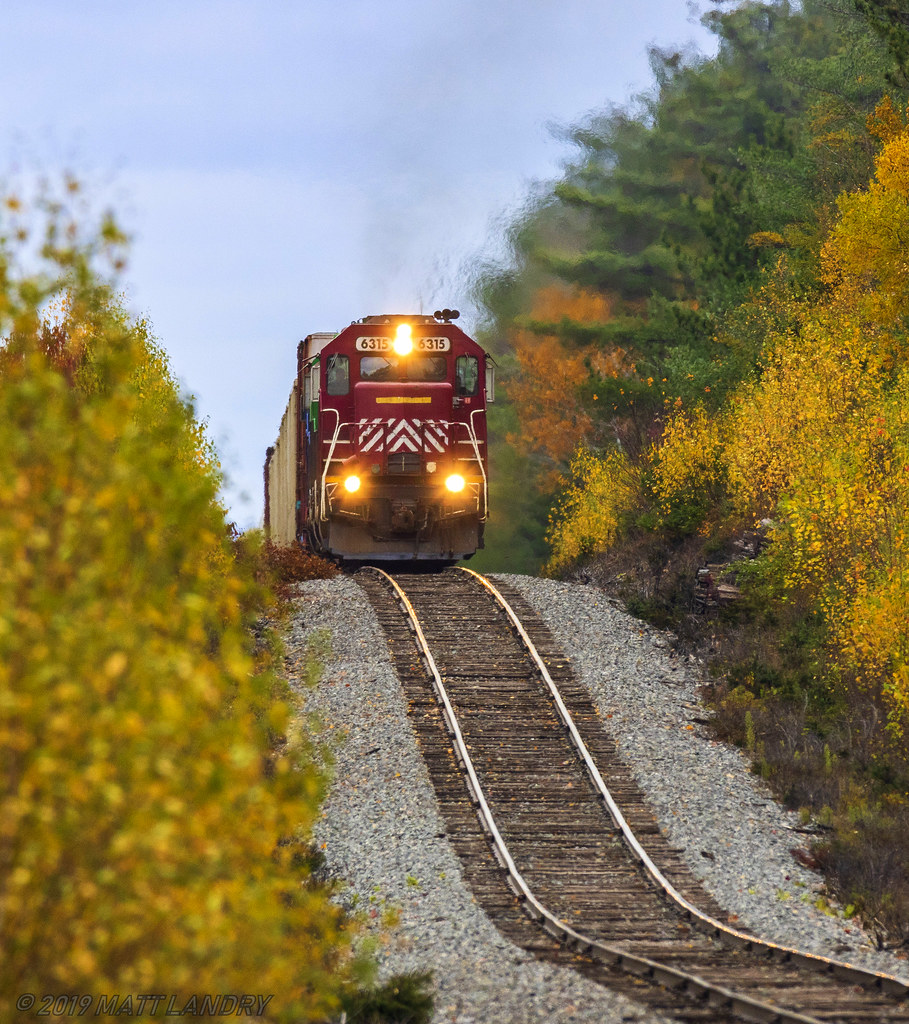 NBSR 6315, still in it's old paint scheme, leads train 907, as they will begin the descent down the dip at Cork, New Brunswick.