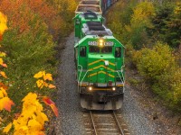During a colorful Thanksgiving Monday, train 907 rumbles by Westfield Beach, New Brunswick. 