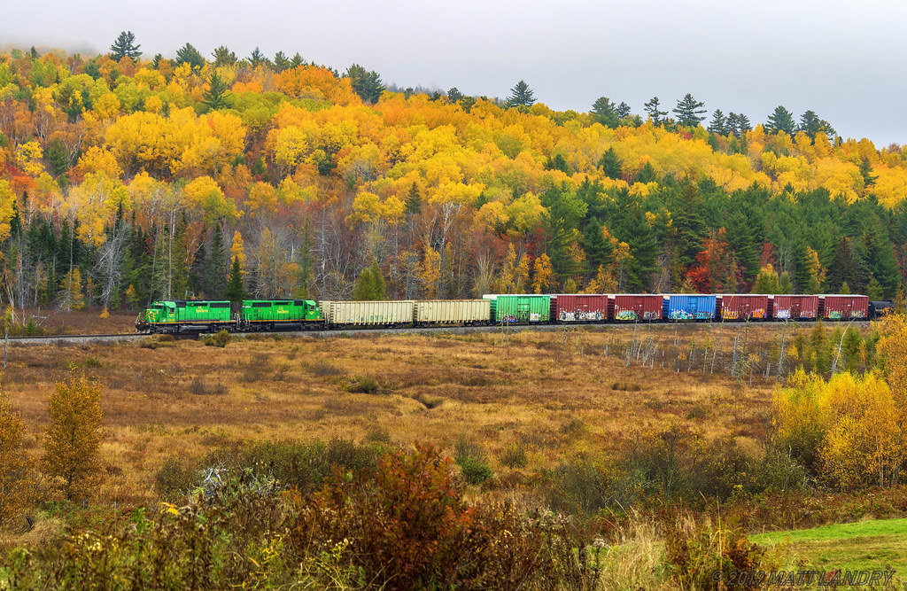 A pair of green power lead NBSR 907 at Clarendon, New Brunswick with a bit of Fall colors left in the hills.