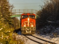 An hour or so before sunset, train 406 is cresting the grade at Quispamsis, and starting their descent down into Rothesay, New Brunsnwick the day after the season's first snowfall. 