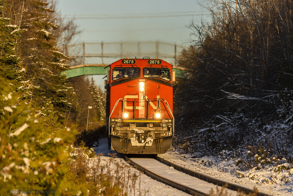 An hour or so before sunset, train 406 is cresting the grade at Quispamsis, and starting their descent down into Rothesay, New Brunsnwick the day after the season's first snowfall.