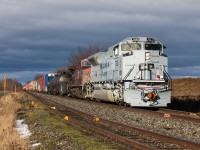 Canadian Pacific 7023 flies along the Macter Subdivision under stormy skies with train no. 112 at Baxter, Ontario.