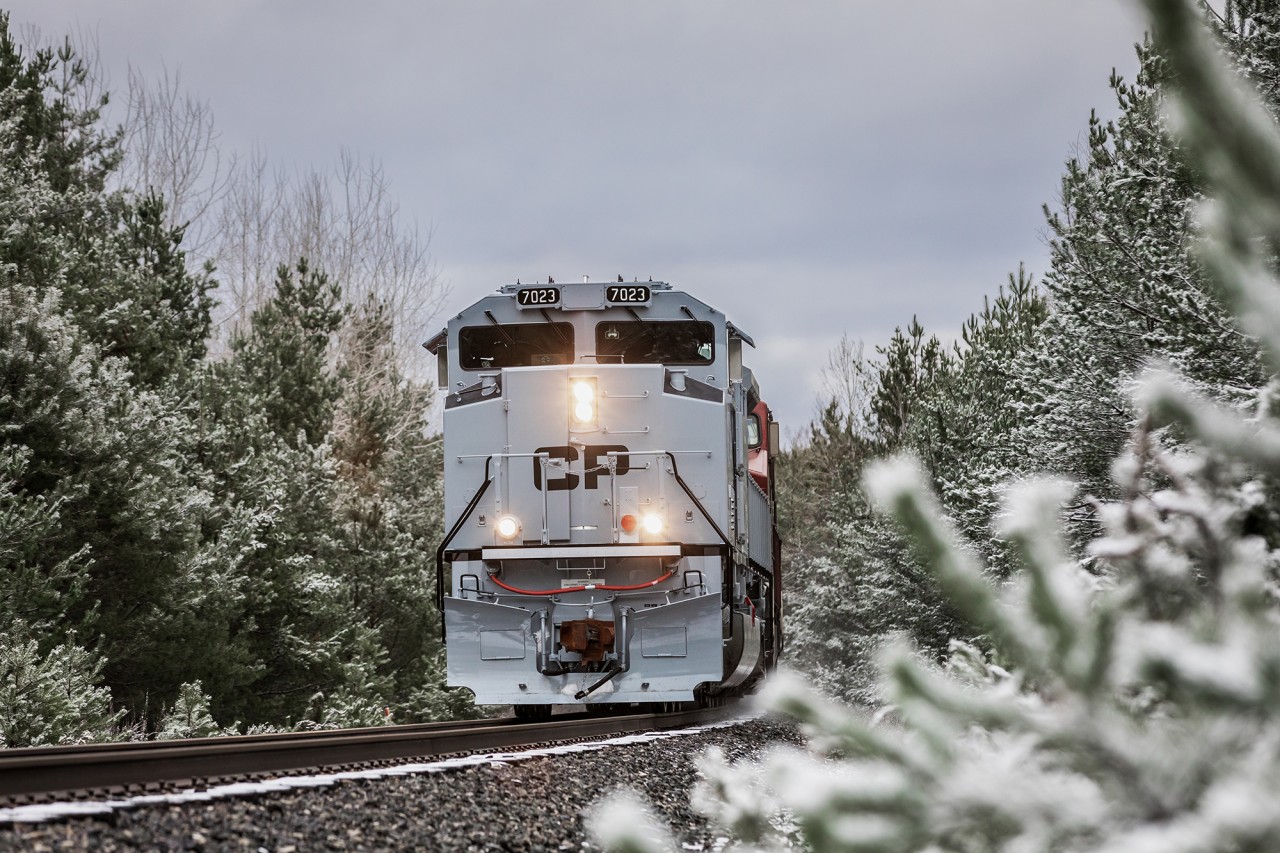Complete with a two-tone grey paint scheme designed after the livery applied to Canadian and American fighter jets, CP 7023 triumphantly hauls Vancouver to Montreal stack train no. 112 down the Mactier Subdivision at Craighurst, Ontario, on her maiden voyage across the country.
