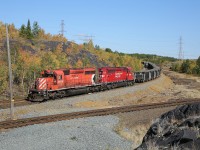 U55 has arrived at CP Sprecher with 46 loaded ore cars from Levack.  6018 and 5035 are now pulling away from the train and will return to Sudbury Yard and soon Vale power will arrive to pull the string of ore cars towards the mill.  The track in the foreground is part of the Vale Railway and connects the Clarabelle Mill complex with the Frood Mine area.