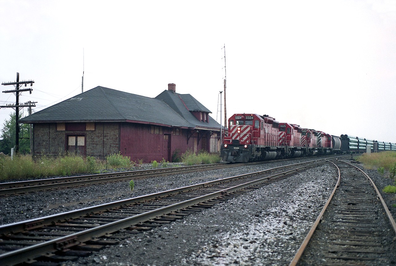 It looks rather quiet around Bolton CP station back in the day before urban sprawl really took hold in the area.
The structure is recently boarded up and about to be demolished.
Heading northbound (west)  is CP train #307 with CP 5504, 5525, 5690 and 5523 the power.
All units off the roster now, of course, with 5504 going to Brazil, 5525 to DME 6082, retired 2013 and sold to HELM, the 5690 scrapped 2016 and the 5523 is now Kiamichi 3377. I recall 5690 (lettered STLH) being assigned to the D&H in the 1990s.
