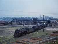 In early 1960, there were long lines of steam locomotives awaiting scrapping at various terminals across Canada. In this photo from the late spring in 1960, we see at least seven steamers awaiting a recall to service that will never come. Identifiable in the photo are the 5236, 5134, and 3459; some of the other engines might be the 2568, 3431, 3423, 8302, and 8385 which were present during previous visits over the winter. (Another photo taken the same day reveals the diesels to be GP9s 4513, 4458, and 4512; S4s 8146 and 8175, S7 8211, NW2 7945, and two other S4 or S7 MLW switchers.)