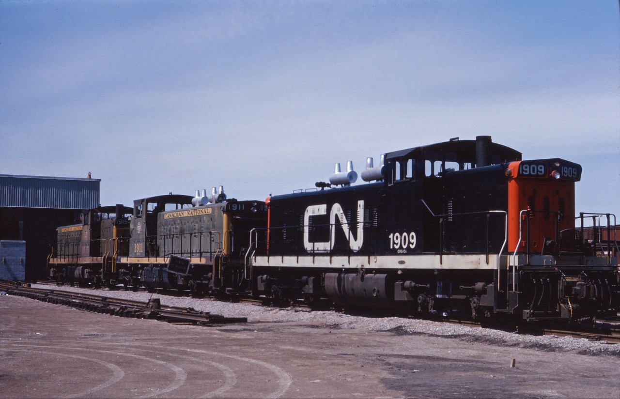 Three steam generator equipped GMD1s (1909, 1911, and 1915) sit outside the almost completed Diesel Shop in Hamilton in the spring of 1964. These units likely came into town on the evening commuter trains and will return to Toronto on Monday morning. Note the difference in frame striping between the 1911 and 1915!