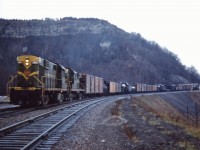 The sombre mood seems to match the miserable weather as a westbound freight with two RS18s (3845 and possibly 3722) struggles up the Copetown hill near the Dundas station in late 1959. In the consist we can see three steam locomotives (Grand Trunk 2-8-2s 3703, 3709 and an unidentified engine) making what is likely their final trip, probably to the reclamation yard in London for scrapping.