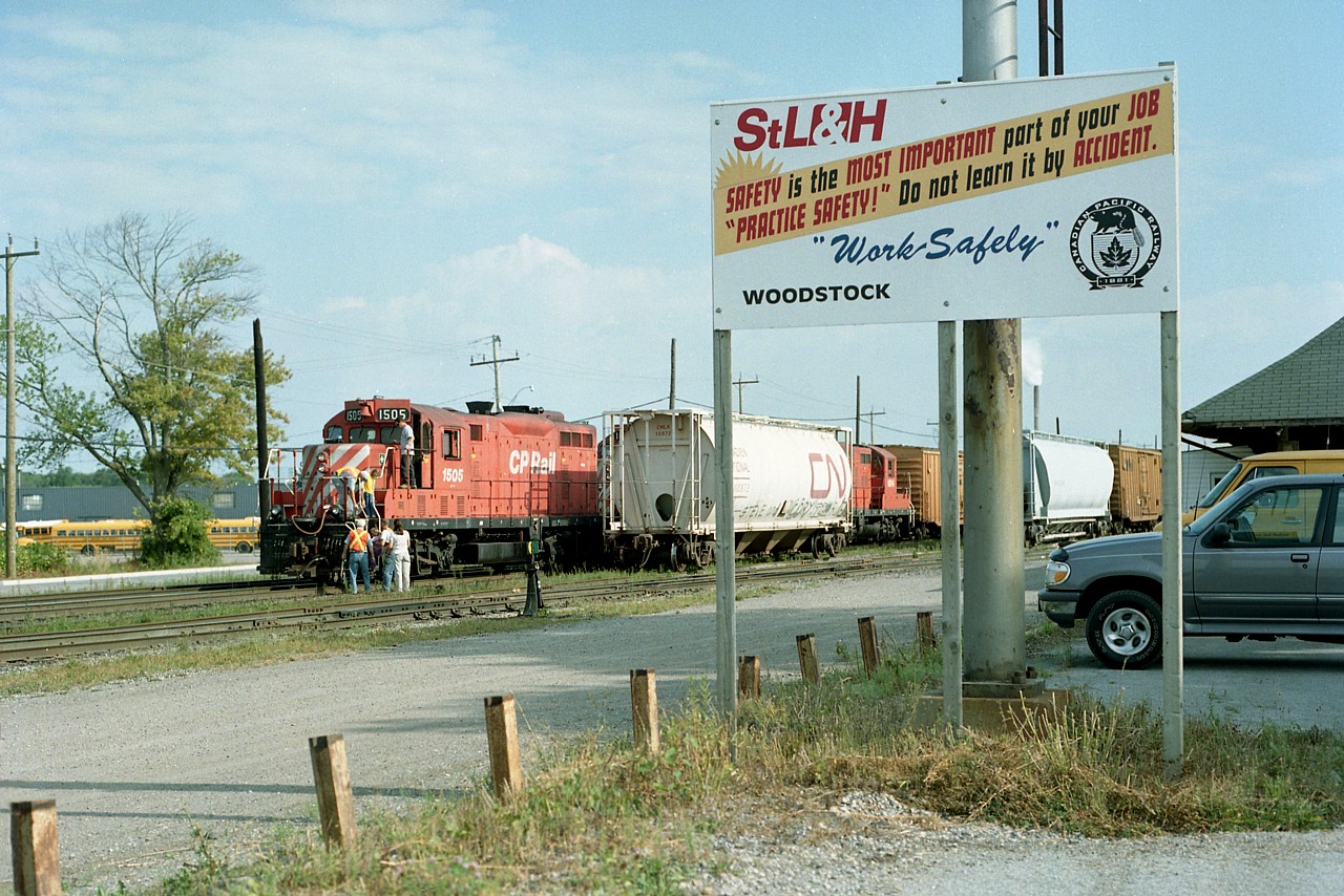 It looks like "family day" at the old STLH Woodstock, as youngsters are being assisted up and down in order they get to enjoy the view out of a locomotive cab.
The sign should date this photo, as STLH was a brainwave of CP to create a separate identity for the Eastern Operations of CP beginning in late 1996. The idea floundered, and STLH was absorbed back into CP on Jan 1, 2001.
Eight months later this sign is still up, a testament to another odd-ball era in railroading.
CP 1505, a GP7, was retired by the end of 2011.