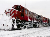 With snow piled high on the front walkways, nose, and caked to the underframes, CP RS18u 1818 and C424 4242 (interesting pair of numbers!) appear to be tied down at Guelph Junction, noted as assigned to the Goderich Wayfreight. Judging by the amount of snow, it looks like the two units may have just made the snowy trip down the line, battling the drifts and lake effect snow along the way.<br><br><i>Reg Button photo, Dan Dell'Unto collection.</i>
