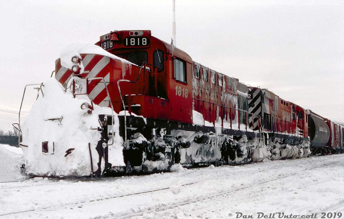 With snow piled high on the front walkways, nose, and caked to the underframes, CP RS18u 1818 and C424 4242 (interesting pair of numbers!) appear to be tied down at Guelph Junction with the Goderich Wayfreight. Judging by the amount of snow, it looks like the pair may have just made the snowy trip down the line, battling drifts and lake effect snow along the way.

Reg Button photo, Dan Dell'Unto collection.