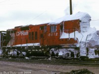 This little Geep probably has an interesting story to tell about its last assignment: CP GP9 8812 sits at Alyth Yard with her pilot, stepwells, and front walkway packed hard with snow, which is also coating the front of her nose and piled up on top of her short hood and cab roof. Perhaps the aftermath of hitting some deep cuts or driftbusting plowed-over grade crossings at speed along some sleepy unplowed branchline out of Calgary working a local (if it had been on a plow run, there would be traces of a power cable for the plow running from the snowed-over 74 volt plug between the grab irons halfway up the nose). It appears the crew elected to de-train out the back of the cab and rear steps, rather than dealing with shoveling their way out the front.<br><br><i>Doug Wingfield photo, Dan Dell'Unto collection.</i>